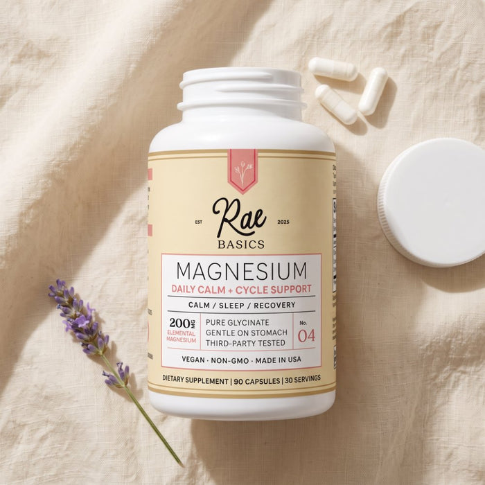 NO. 04 Magnesium Glycinate bottle on soft linen with three capsules and a sprig of lavender